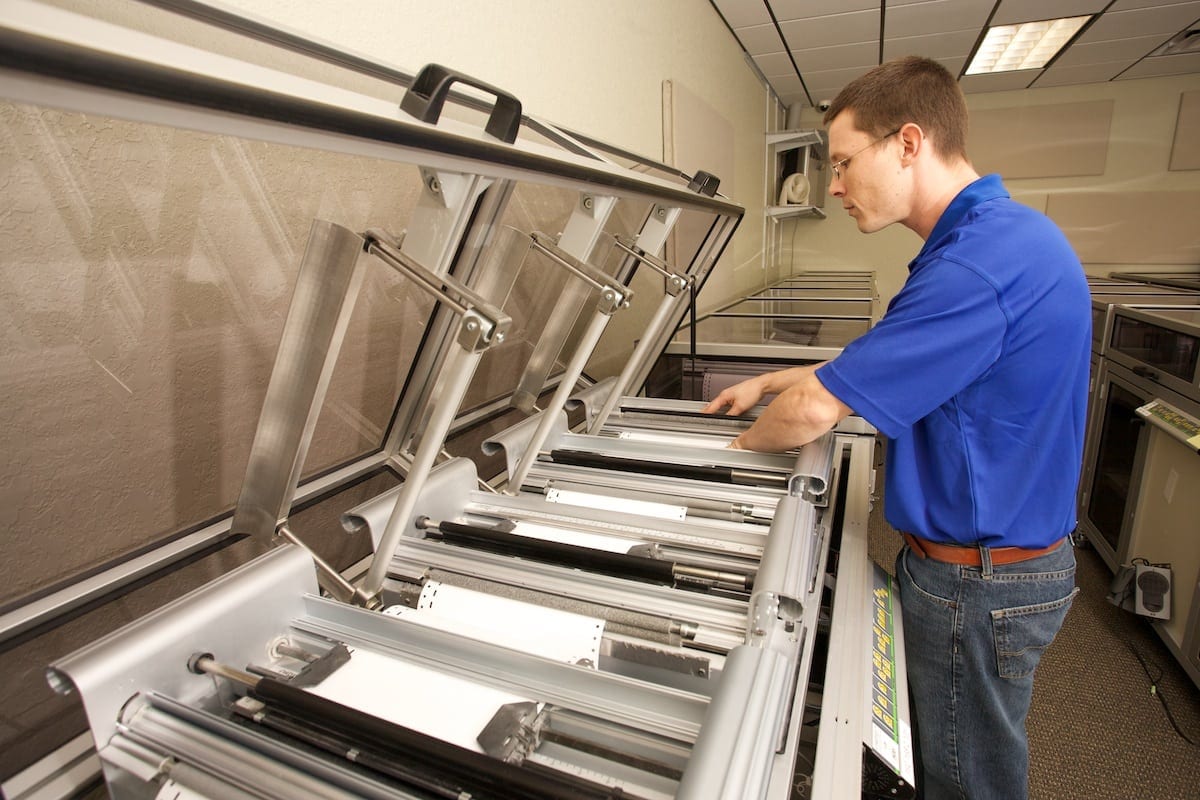 Braille Works staff printing on a top of the line embosser