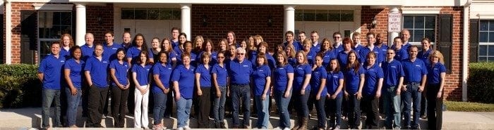 Image of the Braille Works staff standing together in front of the office.