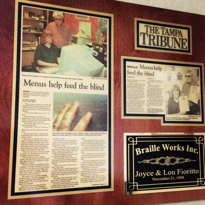 Image showing a framed Tampa Tribune new article about Braille Works from 1998