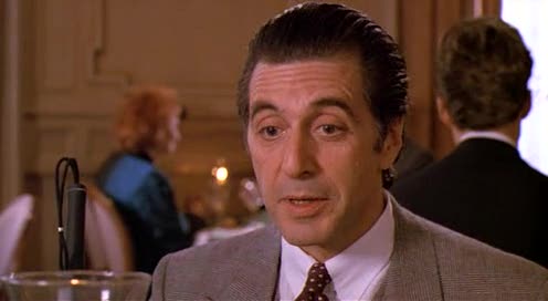 Frank Slade (Al Pacino) sitting at a table in a fancy restaurant during a scene of Scent of a Woman