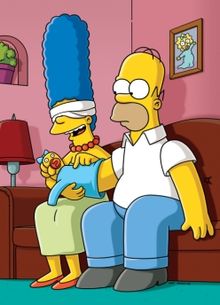 Blindfolded Marge Simpson sitting on the coach with Homer during episode #433 of The Simpsons