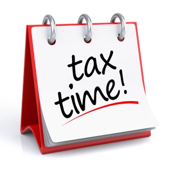 Desktop calendar graphic with the words "tax time!" displayed