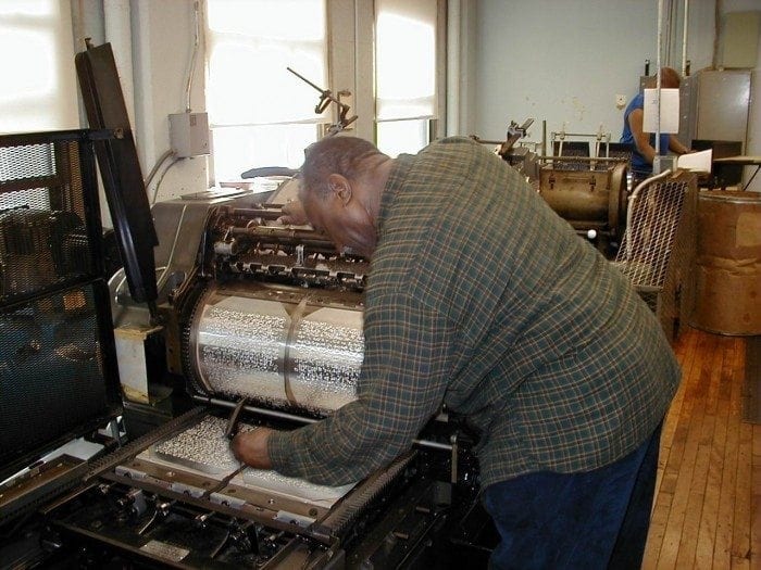 Image showing a man operating a braille press machine.