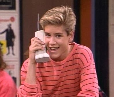 Image showing Zack Morris from the popular 90's TV show "Saved By The Bell" talking on a oversized early model cell phone.
