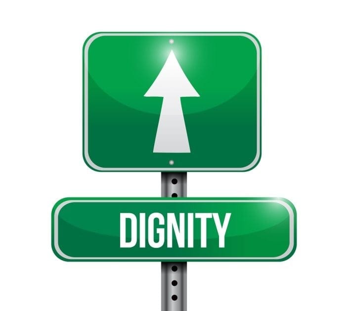 Image showing a green street sign with the word "dignity" displayed and an arrow pointing forward.