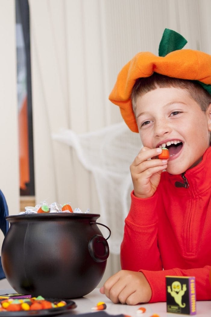 Image showing a young boy snacking on Halloween candy