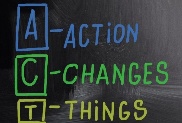 Graphical image of a chalkboard with the words "Action Changes Things" written on it in blue, green and yellow chalk.