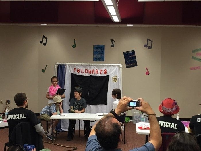Image showing Jeff Frcho, a member of the Braille Works marketing team, watching a Odyssey of the Mind team perform. Image showing Jeff Frcho, a member of the Braille Works marketing team, watching a Odyssey of the Mind team perform.