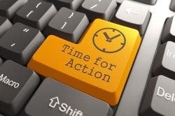 Close-up view of a computer keyboard with a yellow key displaying the words Time For Action.