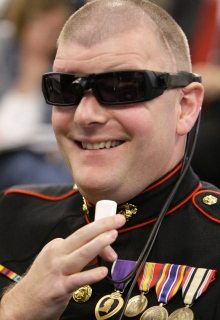 Image of a retired Marine who lost both eyes in an explosion in Iraq demonstrating the BrainPort V100.
