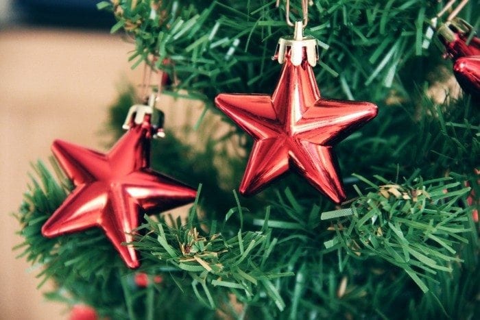 Close-up of a plastic Christmas tree and two star-shaped ornaments.