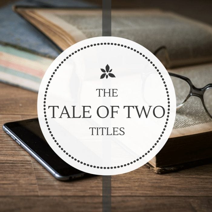 Book, glasses and smartphone sitting on a desktop with the words "The Tale of Two Titles" displayed