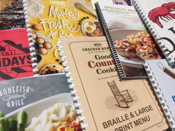 Several braille and large print restaurant menus.