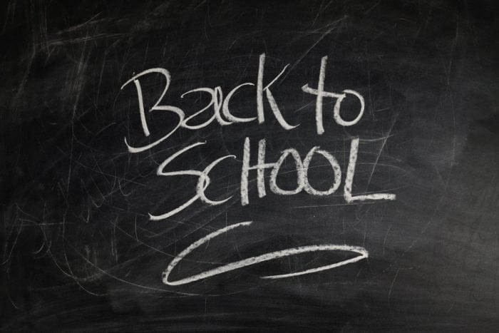 Chalkboard with the words "Back to School" written in white chalk.