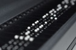 Close up view of braille characters being displayed on a Braille reader device.