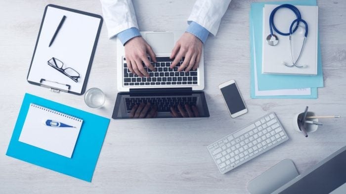 Overhead view of a healthcare professional's desktop.