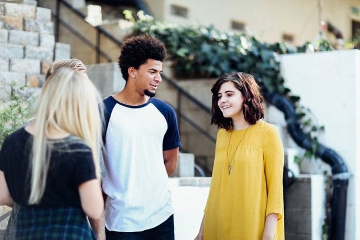 Three people talking to each other.