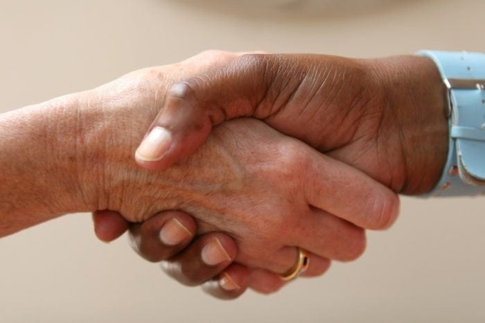 Two people shaking hands in agreement.