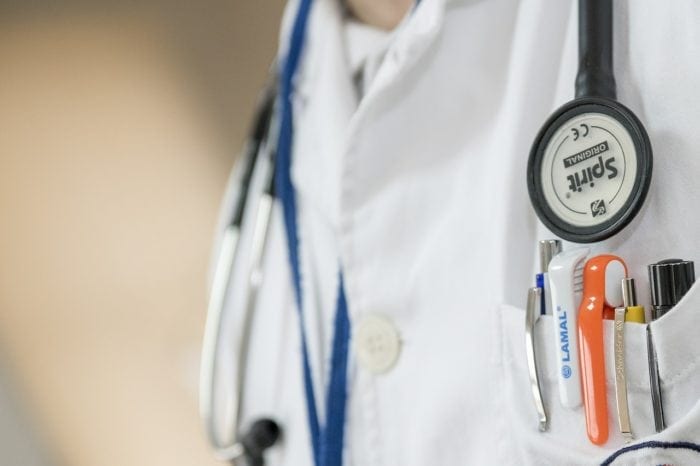 Close up of a doctor's stethoscope and white coat