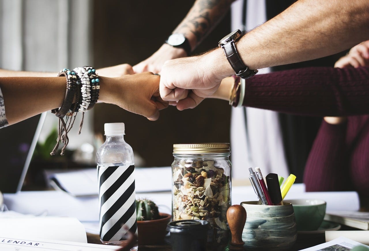 group fist bumping with their document accessibility partner