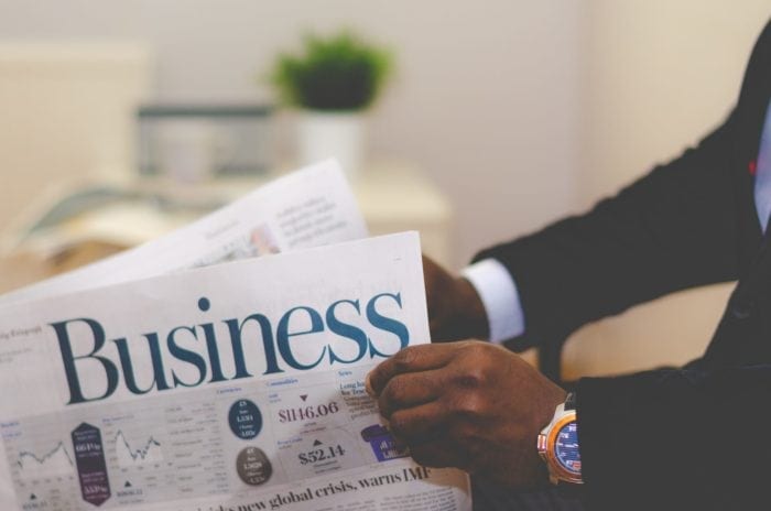 African American business man reading the business part of the newspaper.