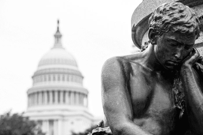 thinking man statue in front of the U.S. Capitol representing government agencies