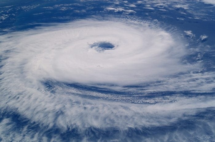 Massive hurricane swirls over blue water