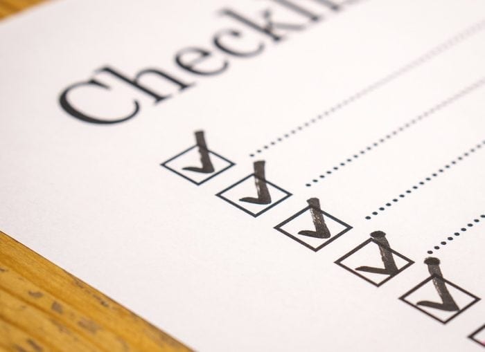 a sheet ofpaper with the heading "Checklist" and five checkboxes with check marks.