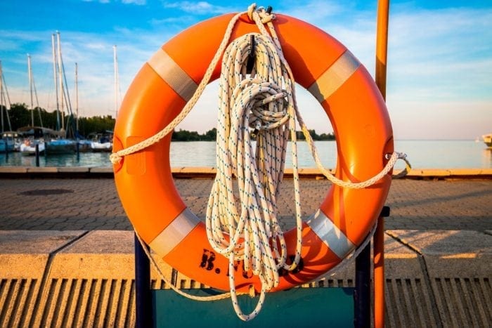 life preserver hanging on a dock over the water