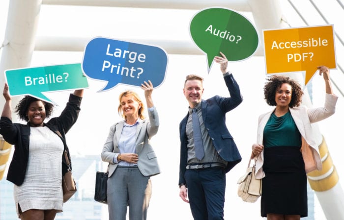 Four smiling people holding speech bubble signs over their heads that say Braille? Large Print? Audio? Accessible PDF?