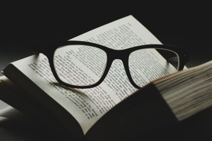 Eyeglasses placed in the middle of an open book