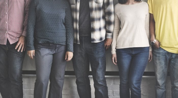 5 people shown from their shoulders to just below their knees standing next to each other