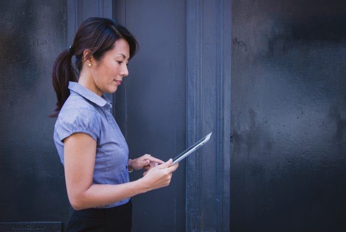 businesswoman searching the internet on an ipad