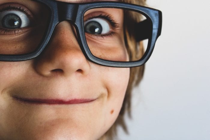 a closeup of a child with glasses