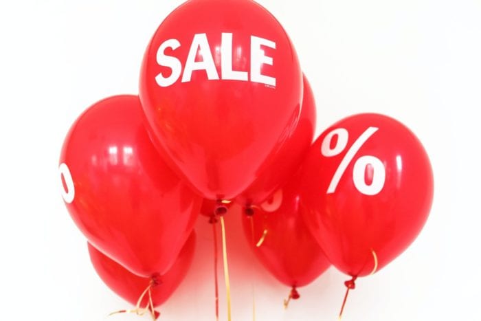 Cluster of balloons with the word "sale" or a percent sign printed on them