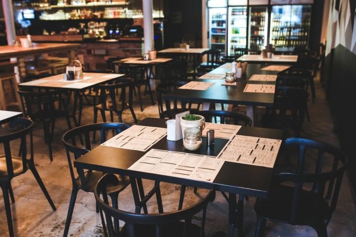 empty dining area at a restaurant with a menu at each seat