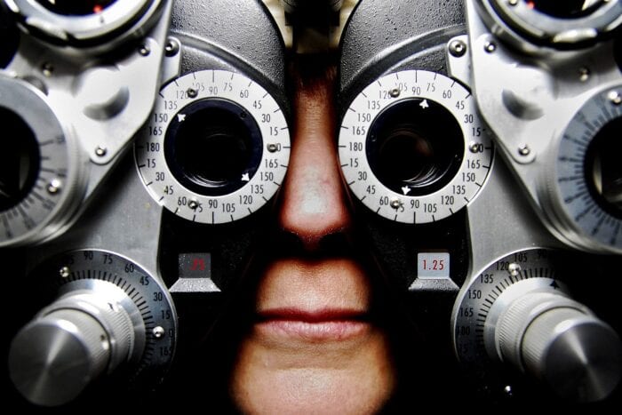 Nose and mouth of a person with their face in an eye exam machine