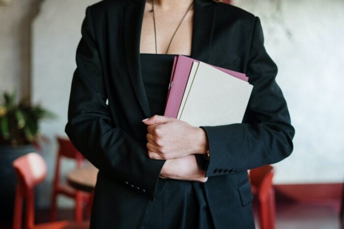 a hostess holding disposable menus
