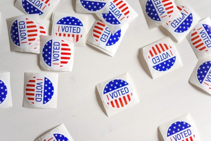Several individually cut, round "I Voted" stickers