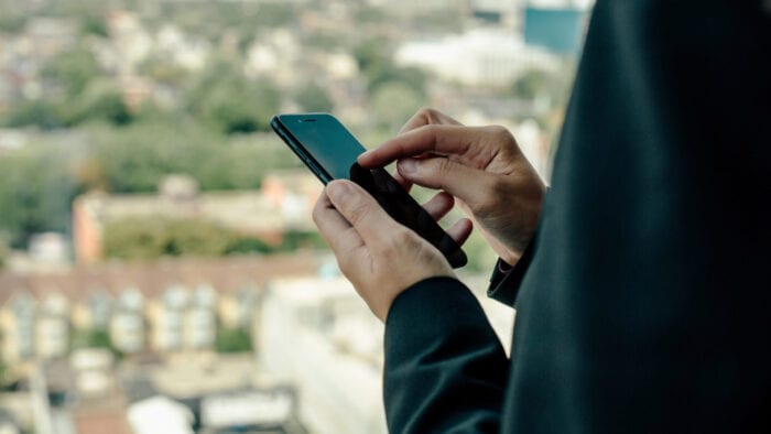 Close-up of hands holding and using a smart phone