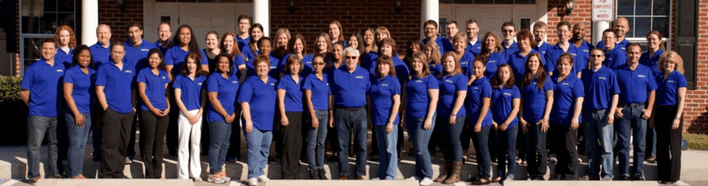 Image of the Braille Works staff standing together in front of the office (January 2014).