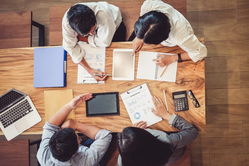 group of people working together at a table